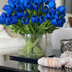 Arrangement of blue tulips in a large cylindrical vase – The Ever Botanic